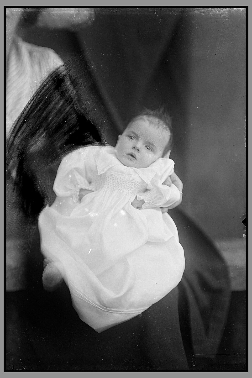 Retouche d'une hidden mother sur négatif en verre Négatif photographique de 1921 montrant la retouche destinée à masquer la mère derrière un bébé