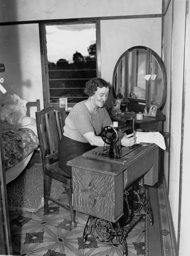 femme machine coudre singer 1944 femme utilisant une machine à coudre Singer à pédale en 1944